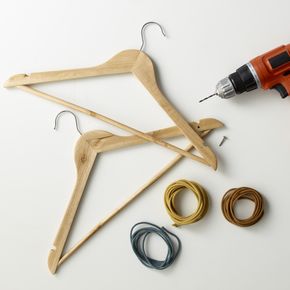 Wooden hangers, coloured cords, drill and screws as DIY materials
