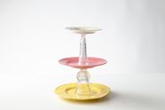 DIY cake stand made from glasses and plates as table decoration 